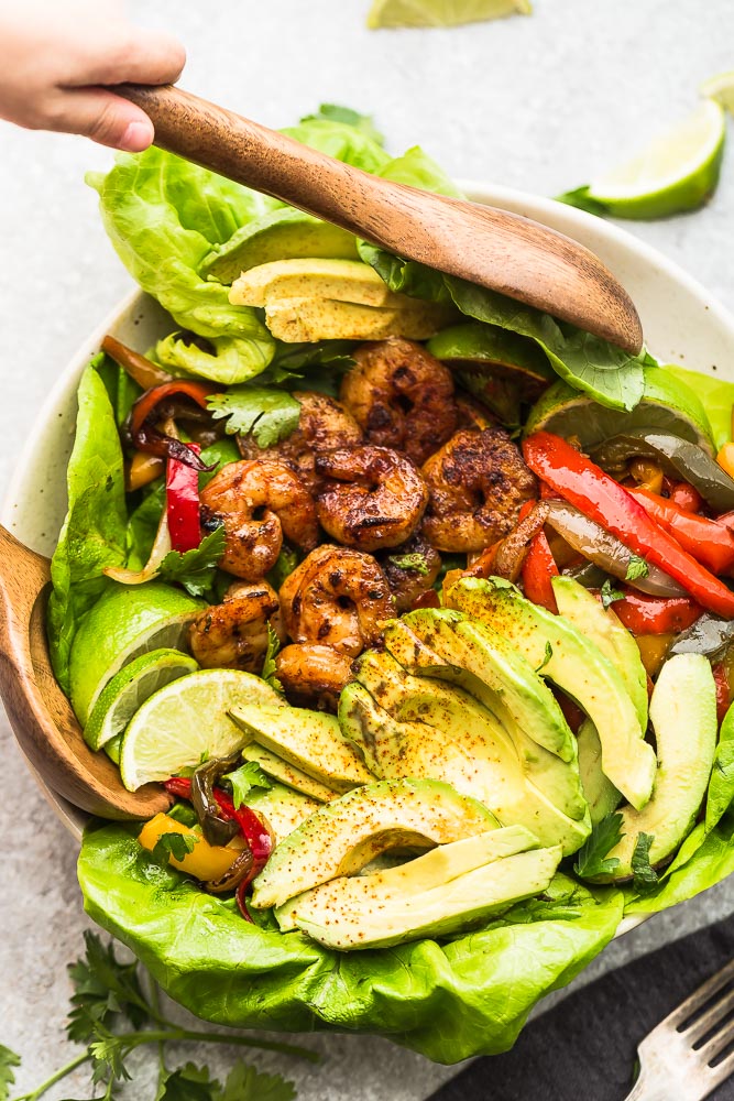 Low Carb Sheet Pan Shrimp Fajitas are tender, juicy and full of flavor! Best of all, they come together super quick and are perfect for busy weeknights. Marinated in a homemade fajita spice blend and cilantro lime marinade.