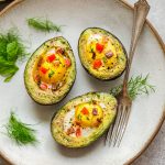Avocado Egg Boats baked with crispy bacon and bell peppers are the perfect easy breakfast to start the day. This simple low carb, keto and paleo friendly recipe comes together in less than 30 minutes.