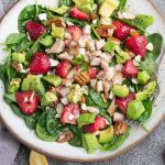 Strawberry Avocado Spinach Salad - the perfect healthy low carb lunch or light dinner. Made with fresh greens, creamy avocado, sweet strawberries, pecans, almonds and crumbled cheese.