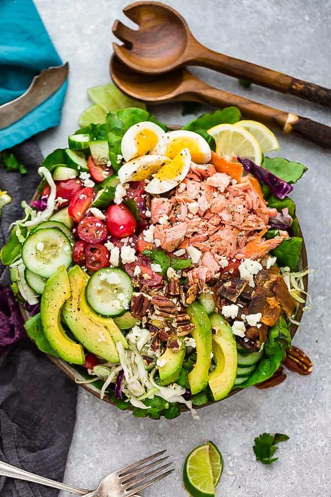 Keto Salmon Salad - a delicious loaded meal made with grilled or broiled salmon, cucumber, eggs, tomatoes, avocado, crispy bacon and a creamy and tangy vinaigrette. Low carb, keto , gluten free with Whole 30 & paleo friendly options.