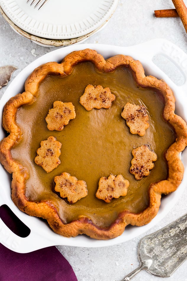 A delicious low carb pumpkin pie recipe with all the delicious flavors of a traditional pumpkin pie. Made with a flaky and buttery crust with a smooth and creamy Paleo-friendly custard filling with cozy fall spices.